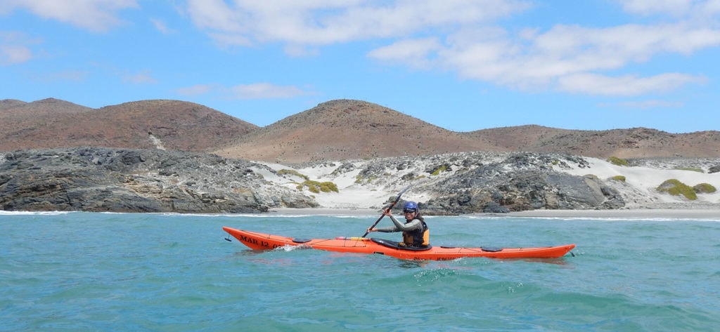 Sea kayaker exploring overfalls on the coastline