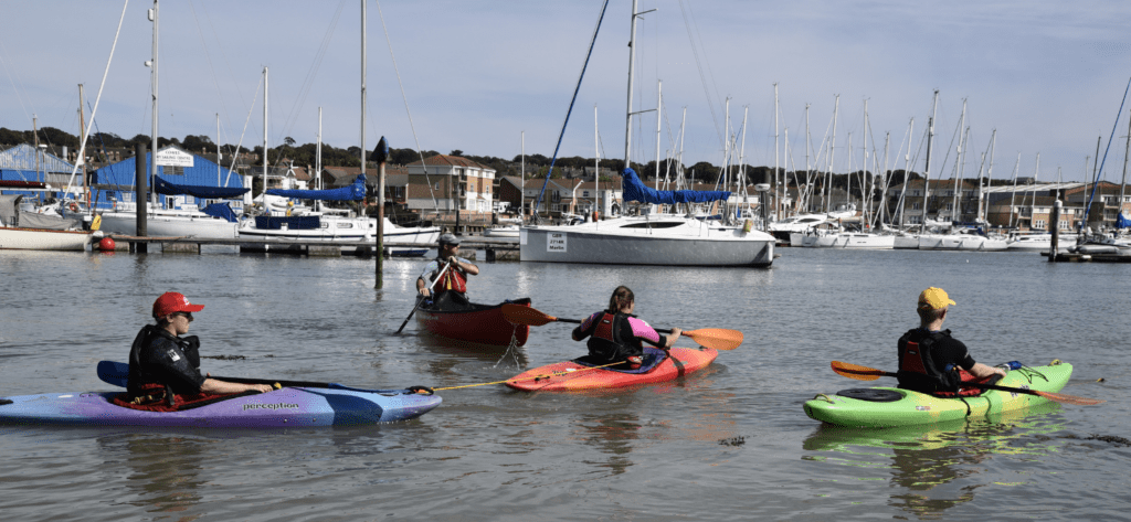 Canoe and Kayak paddlers practising in a harbour