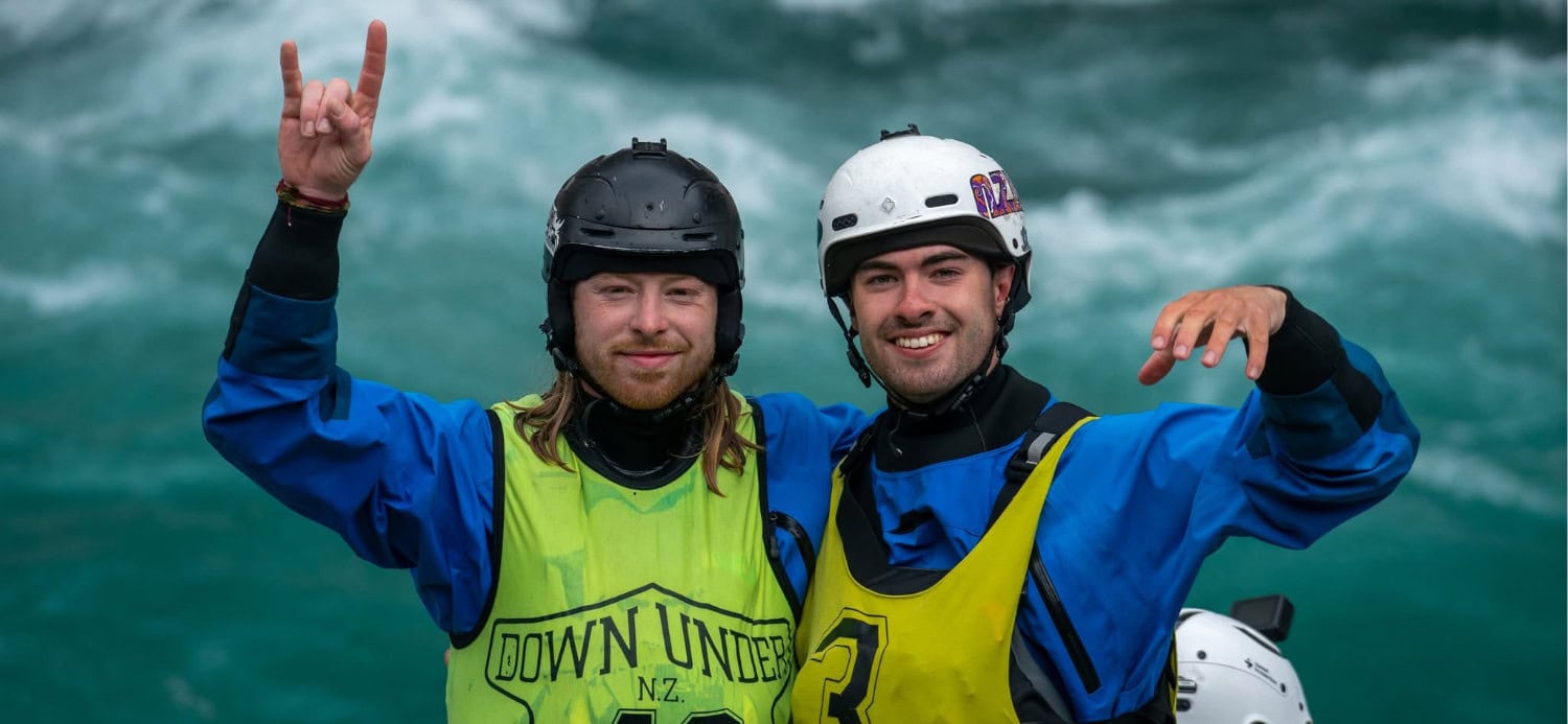Image of Alex Littlechild and friend smiling wearing paddling kit.